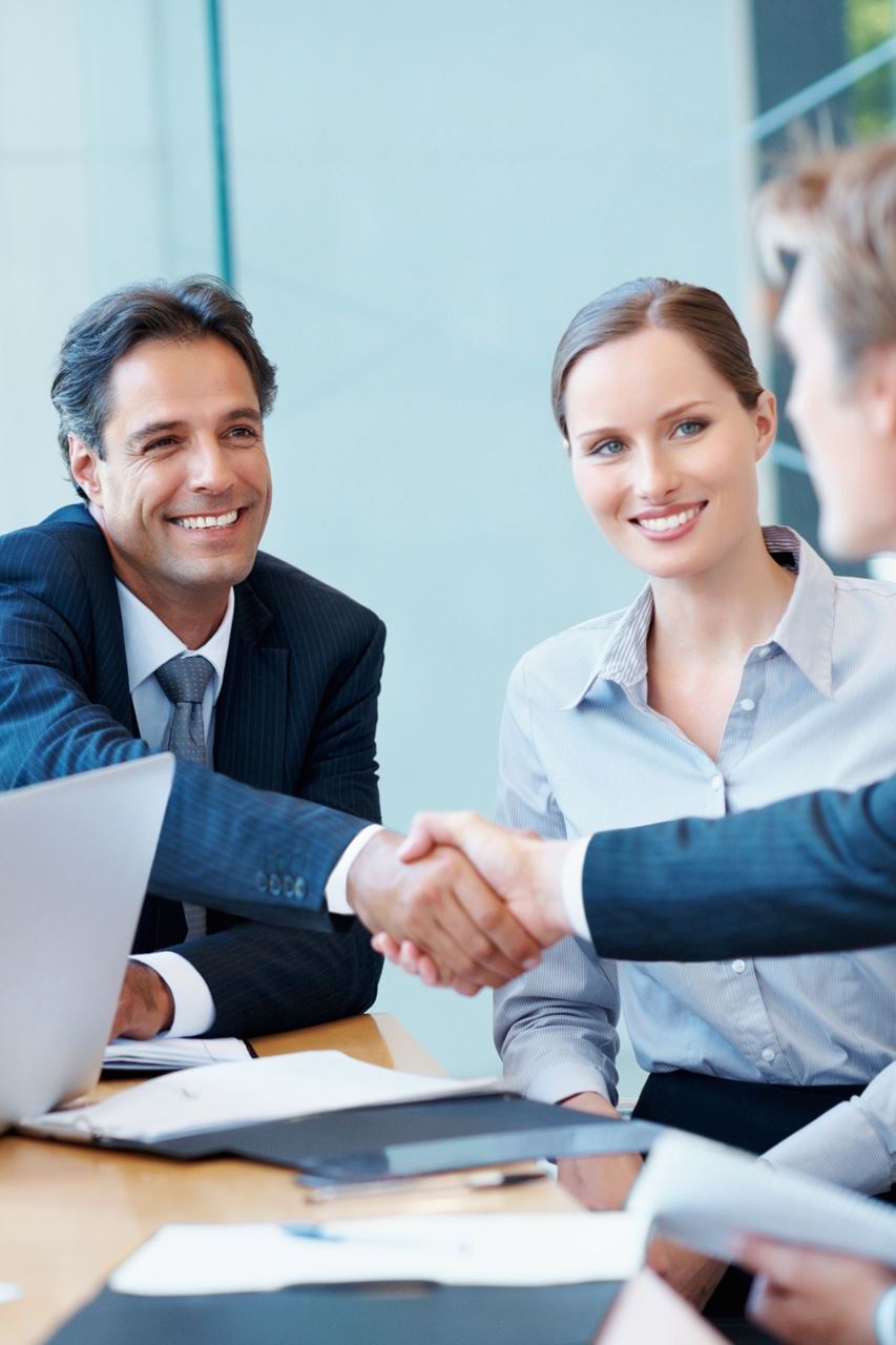 Businessman and his partner shaking hands with a client